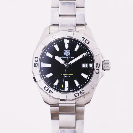 Tag Heuer Aquaracer, ref WBD1110, snr WUZ2502, quartz, stållenke, riper på beott, lenke og glass, slitt etui og pute, ingen øvrig tilbehør.  Vekt: 0 g Kontakt Lånekontoret for frakt