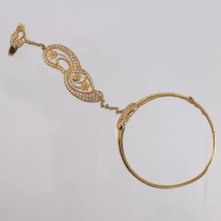 Armring med ekstralenke og blanke stener, ø59mm, bredde 3,2- 15,3mm, 21K Vekt: 20,1 g Kontakt Lånekontoret for frakt