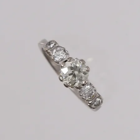 Ring med briljantslipte diamanter (1 x ca. 0,90ct + 2 x ca. 0,15ct + 2 x ca. 0,08ct), ø17mm, bredde 2,7- 6,9mm, hvitt gull, 14K Vekt: 4,6 g Kontakt Lånekontoret for frakt