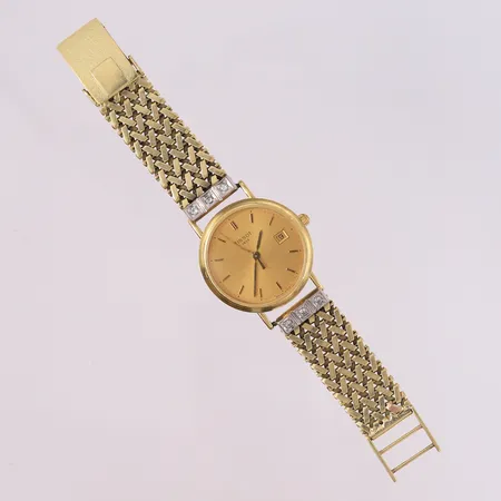 Tissot armbåndsur i 18K gull (lenke er 14K) med diamanter (6 x ca. 0,02ct), to-farget, boettnummer G614.330, quartz, total lenkelengde 12cm (OBS! Meget kort), lenkebredde 13,3mm, bøyd sekundviser, ikke funksjonstestet (behøver nytt batteri), bruttovekt 32,1g Vekt: 32,1 g Kontakt Lånekontoret for frakt