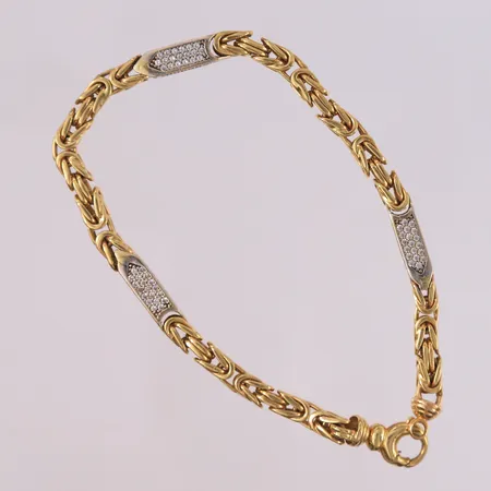 Armbånd Konge med blanke stener, to-farget, lengde 23,5cm, bredde 4,5- 5,2mm, 18K Vekt: 34,5 g Kontakt Lånekontoret for frakt