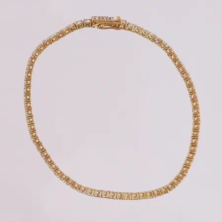 Tennisarmbånd med 72 blanke stener, lengde 18cm, bredde 2,5mm, slitt lås, 18K Vekt: 7,9 g Kontakt Lånekontoret for frakt