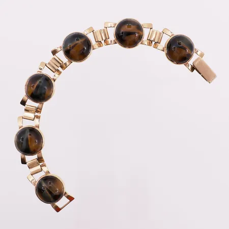 Armbånd trolig tigerøyne, lengde 18 cm, bredde 14,8 mm, 9K Vekt: 27,3 g Kontakt Lånekontoret for frakt