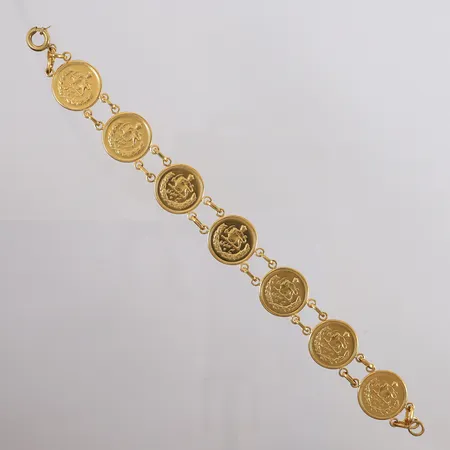 Armbånd med 7 mynter, lengde 22,5cm, bredde 4,5- 20,2mm, 20K (myntene er 900/1000 = 21,6K), bruttovekt 36,8g Vekt: 0 g Kontakt Lånekontoret for frakt