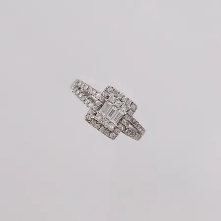 Ring med 55 stk. diamanter (46 briljantslipte, 6 prinsesseslipte, 3 baguetteslipte, totalt 0,50ct W / P iht. medfølgende kvittering), ø15,5mm, bredde 1,5- 9,2mm, hvitt gull, 14K, bruttovekt 2,6g Vekt: 0 g Kontakt Lånekontoret for frakt