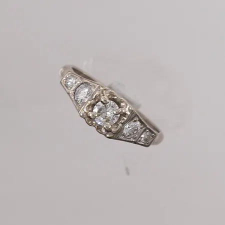 Ring med diamanter (1x ca 0,30ct, 2x ca 0,15ct og 2x ca 0,03ct), ø17,5mm, bredde ca 2,5mm, 14K gull. Vekt: 4,2 g Kontakt Lånekontoret for frakt