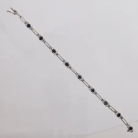 Armbånd med sannsynligvis safirer og diamanter 36x ca 0,02ct, lengde ca 18,5cm, bredde ca 3,4-5,6mm, noe slitasje, 18K hvitt gull, bruttovekt 16,5g. Kontakt Lånekontoret for frakt