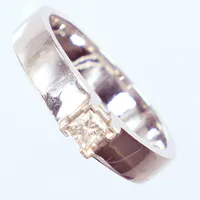 Ring med princesslipad diamant WSI, totalt 0,25ct, Ø18¼, bredd 4mm, vitguld, 18K  Vikt: 6,3 g