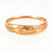 Ring i 18K guld med tre diamanter á c:a 0,005ct. Den är 1,3 - 5 mm bred, är i storlek 19¼ och väger 1,9g. Stämplad GFAB (Guldfynd) & 750. Aningen vass skena.