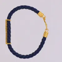 Armband, flätat konstläder med gulddekor, längd 17,5cm, 23K/18K Bruttovikt 10,7g 