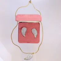 Smyckesset, Pierre Cardin, bestående av kedja, hängd, ett par örhängen med clips, oädel metall med vita stenar, kedjans längd 45cm, i originalaskar, askar med slitage Vikt: 0 g