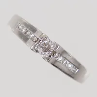 Ring, diamanter, 4 prinsesslipade diamanter ca 0,02ct + 10 briljantslipade diamanter ca 0,01ct, stl 18½, bredd 1,8 - 4,7mm, vitguld GHA 18K Vikt: 5,1 g