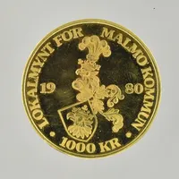 Lokalmynt för Malmö kommun, 1000 kr, år 1980, Ø27 mm, plastkassett medföljer, 18K. Vikt: 10 g