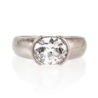 Ring i silver med en vit sten. Den är 3,2 - 8,9 mm bred, är i storlek 18¾ och väger 5,5g. Stämplad 925.
