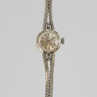 Damur Ondina de luxe 18K, 15mm, manuell, integrerad länk i vitguld med diamanter 4 x ca. 0,005ct, längd inklusive uret: ca 16,5cm, bruttovikt: 17,2g
