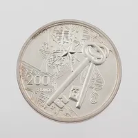Minnesmynt Sverige " 200 Kronor - Kungliga Slottet Stockholm 250 År - 2004", silver 925/1000, Ø36 mm, utgiven av Sveriges Riksbank, förvaras i myntkapsel. Vikt: 27 g