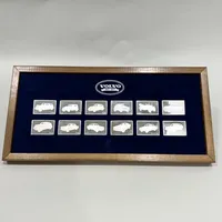 12 Silverplaketter, De Historiska Volvobilarna 1927-1977, 25x38mm, i etui med slitage, äkthetsintyg, silver 925/1000, vikt ca 227g Vikt: 227 g