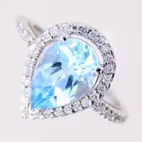 Ring med droppformad topas samt briljantslipade diamanter 40 x 0,0075ct, stl: 17, bredd 1,5-15,8mm, vitguld 18K.  Vikt: 4,4 g