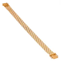 X-länksarmband i 18K guld. Det är 19 cm långt, 13 mm brett och väger 14,8g. Kistlås. Tillverkat 1967 av Ädelsmycken Aktiebolag  i Stockholm. Kattfot.
