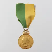 Medalj 18 k, diameter 3.5 cm. Vikt: 23,6 g