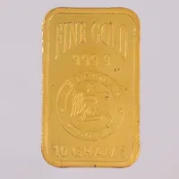 Guldtacka, längd 26mm, bredd 15,5mm, fine gold Emirates Gold 24K, bruten plombering, repor, 24K. Vikt: 10 g