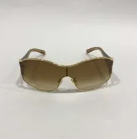 Solglasögon Louis Vuitton, modell-nr: Z0306U, guldfärgade, med bruna stenar samt detaljer i glitter, manual, box samt dustbag