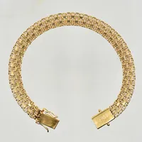 Armband X-länk med stav, längd 19½ cm, bredd 8 mm, 18K. Vikt: 20 g