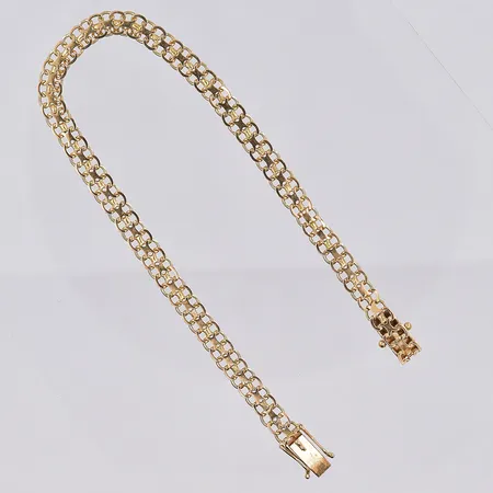 Armband X-länk, längd 19½ cm, bredd 5 mm, mindre klämskador på länk, 18K. Vikt: 6 g