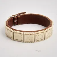 Armband i läder, Sameslöjd, med 12st plattor i renhorn som är mönstrade, längd 17-18,3 cm, bredd 14,4mm.