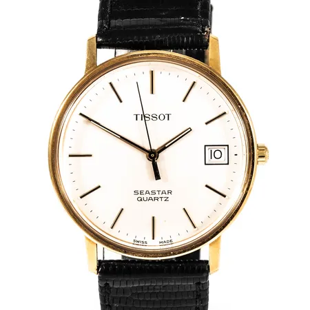 Herrur Tissot Seastar i 18K guld med läderband. Monocoqueboett Ø 33,5 mm med personlig gravyr. Quartz- går ej- batteribyte krävs?