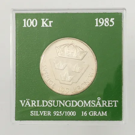 Minnesmynt Ø32mm, Världsungdomsåret 1985, nominellt värde 100 Kronor, plastetui silver 925/1000  Vikt: 15,9 g