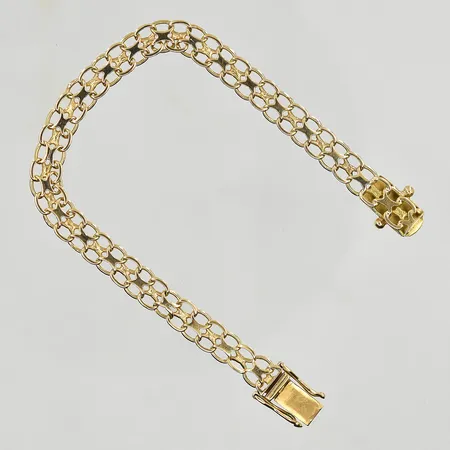 Armband X-länk, längd 17½ cm, bredd 6 mm, mindre klämskador på länk, 18K. Vikt: 9,5 g