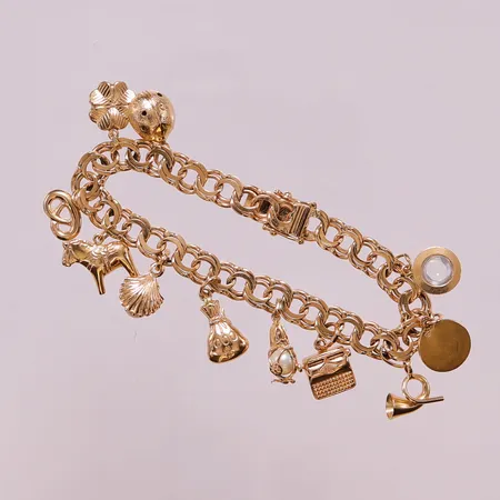 Armband, 18,5cm, bredd:7mm, 11 berlocker, 18K 28,1g.