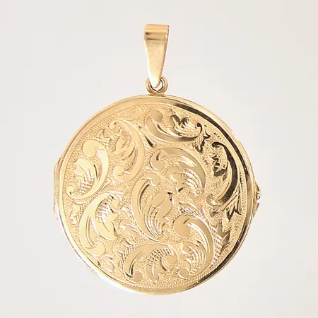 Medaljong med dekor, öppningsbar, Ø29mm, plats på insidan, 18K.  Vikt: 7,5 g