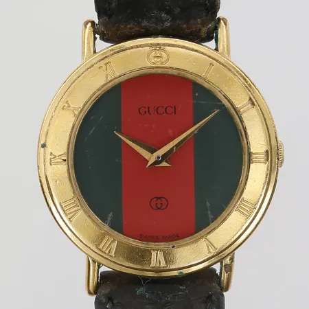 Damur Gucci, Ø26mm, quartz, plexiglas, förgyllt stål, läderarmband, numrerad: 3000 L, serie-nr: 0022013, bruksslitage/repor, läderarmband ej original. 