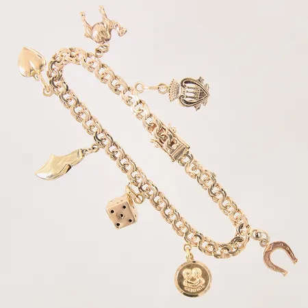 Armband Bismarck med 7 berlocker, längd: 17,5cm, bredd: 5-7mm, 3 berlocker i 14K, något slappt lås, 18K  Vikt: 15,4 g