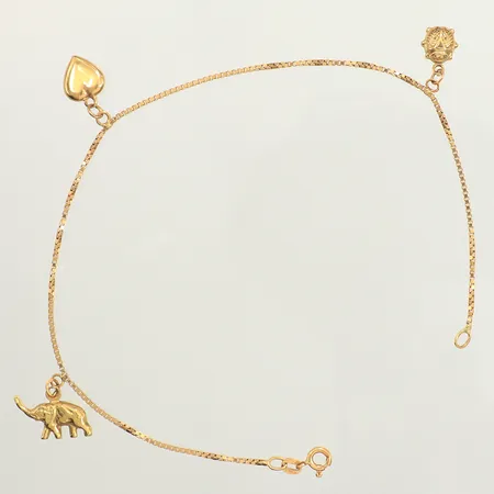 Vristlänk, tre berlocker, längd 25cm, bredd 1,3mm, 18K  Vikt: 5,1 g