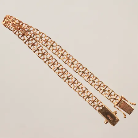 Armband X-länk, längd 17cm, bredd 5mm, vassa kanter vid lås, 18K Vikt: 7,4 g