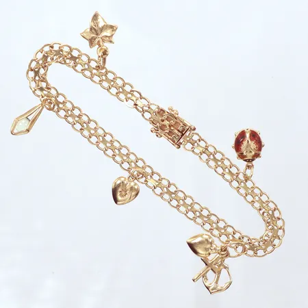 Armband X-länk, Ädelsmycken Aktiebolag, år 1965, 5 berlocker, längd 21cm, bredd 6mm, 18K Vikt: 11,3 g