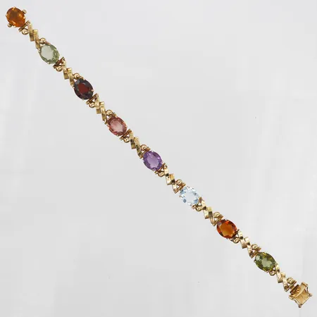 Armband med citrin, prasiolit, granat, turmalin, ametist samt akvamarin, totalt ca 18,30ctv, längd 18,5cm, bredd ca 8-10mm, utländska stämplar, 18K guld Vikt: 21,3 g