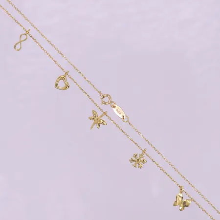 Collier med integrerade berlocker, ca 42cm, bredd 1-10mm. 18K  Vikt: 2,8 g