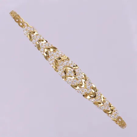Armband med vita stenar, ca 18cm, bredd 2,5-9mm, ojämnheter på länk. 18K Vikt: 6,9 g