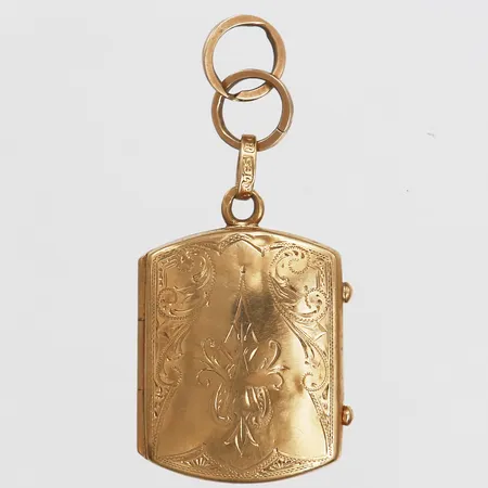 Hänge/Medaljong med blomsterdekor, höjd 30mm, bredd 20mm, två extra öglor, bucklor, 19K guld (765/1000), bruttovikt: 6,0gr Vikt: 6 g