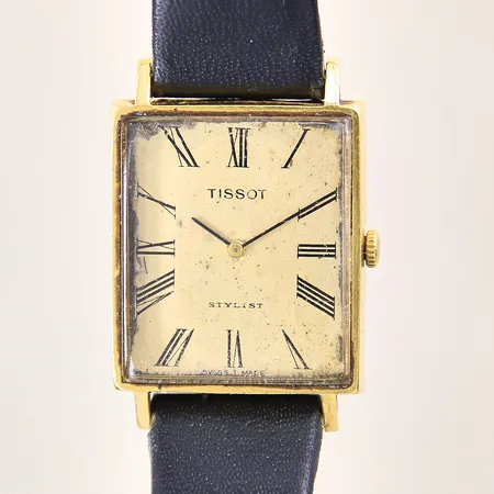 Herrur Tissot Stylist, manuell, 18K, Ø28x26mm, läderband med skador samt slitage, defekt urtavla, boett med repor samt bucklor, repigt glas, inga tillbehör, bruttovikt: 22,8g