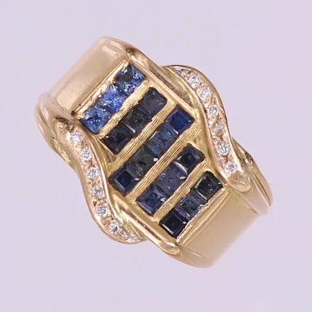 Ring med troligen 19 safirer samt briljantslipade diamanter 12 x ca 0,01ct, stl: 20¼, bredd 6-16mm, flertalet stenar skadade, skador på skena, gravyr, 18K.  Vikt: 22,3 g