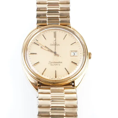 Herrur Omega Seamaster, quartz, guld på stål, ca 36mm, repigt glas, batteribyte krävs, stretchlänk