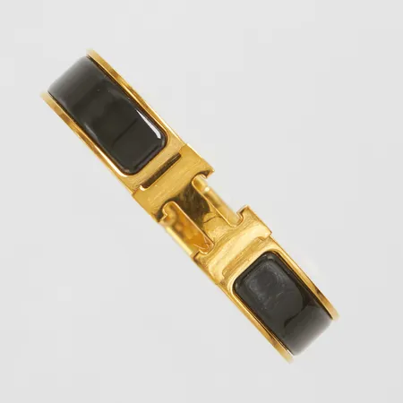 Armband, Hermès Clic Clac H, guldfärgad metall med svartemalj, ca 55x45mm, märkt Hermès Made in France, bredd:11,5mm, ytliga repor, inga tillbehör