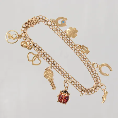 Armband, X-länk, 20cm, bredd 5,9mm, 10 berlocker, en tom ögla, Stockholm 1959, 18K Vikt: 15,2 g