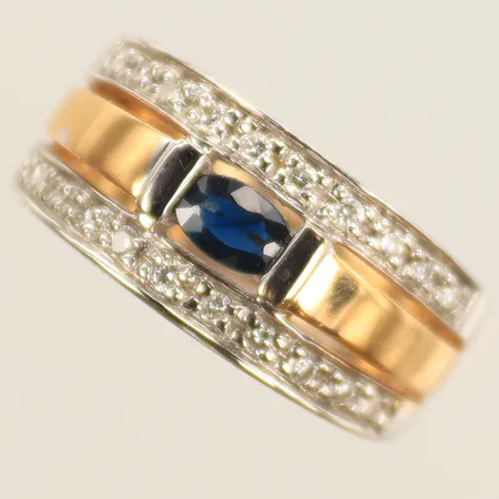 Ring rg/vg med blå sten och 20 diamanter 0,20ct enl gravyr, stl 16, bredd 3,5-8,5mm, 18K 5,4g Vikt: 5,4 g