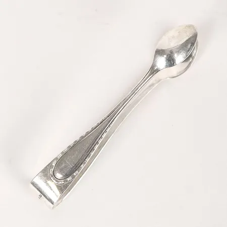 Sockertång, Guldsmedsaktiebolaget i Stockholm, 1916 Stockholm, längd: 10,4cm, bredd: 14mm, 830/1000 silver. Vikt: 20,8 g